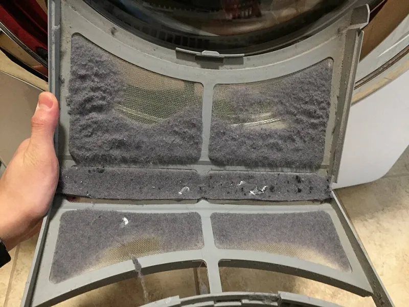 That Gray Fluff in Your Dryer Trap Is Trying to Tell You Something